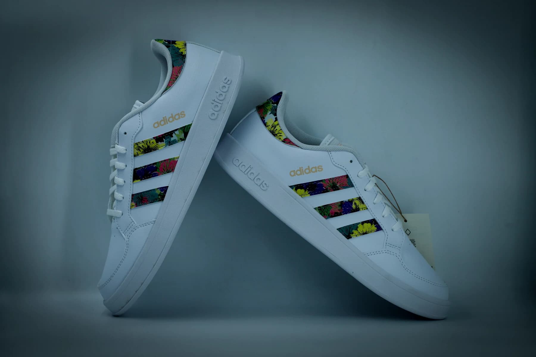 Pair of white sneakers with colorful accents