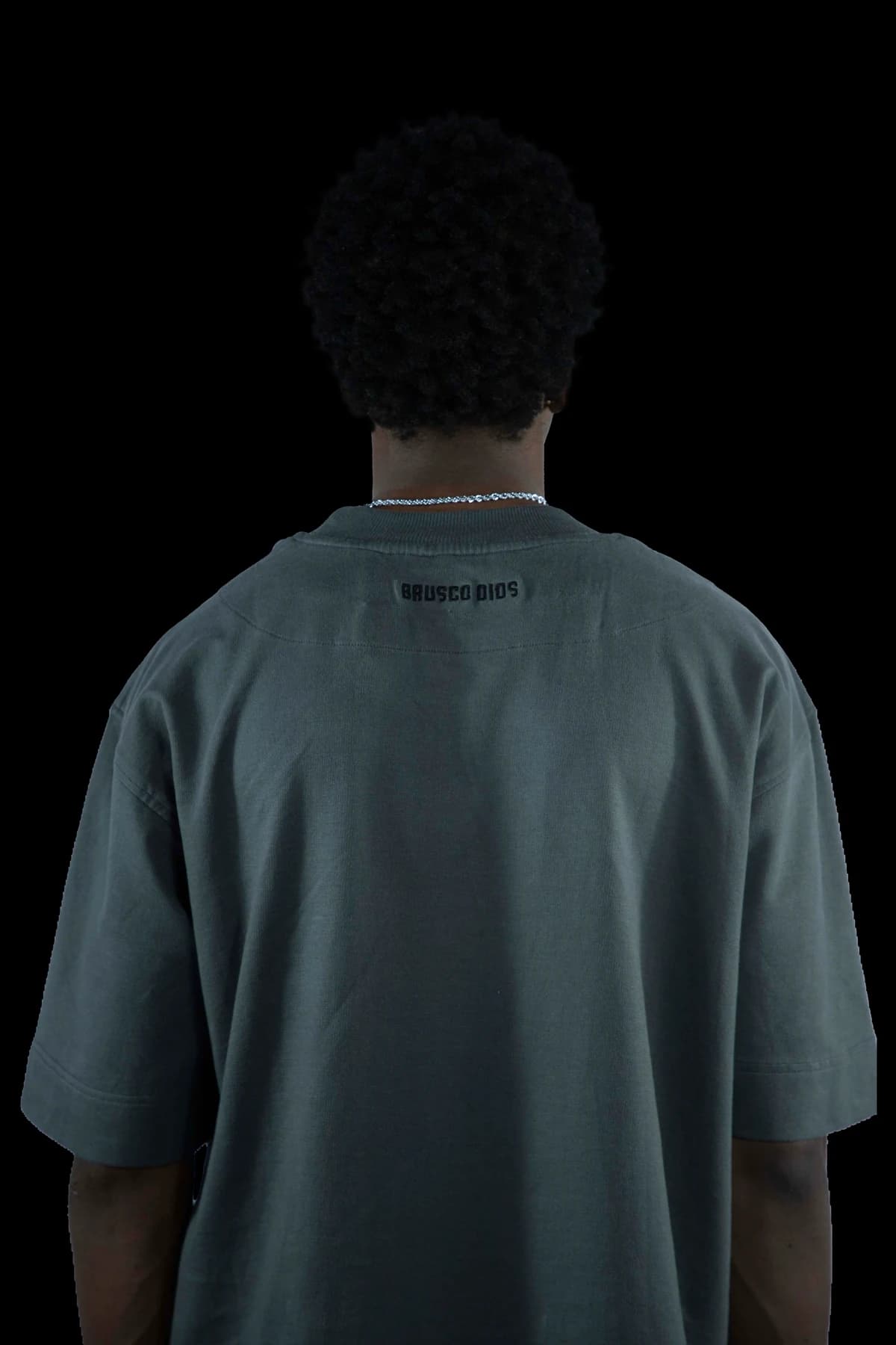 Back view of an apparel model in a dark studio