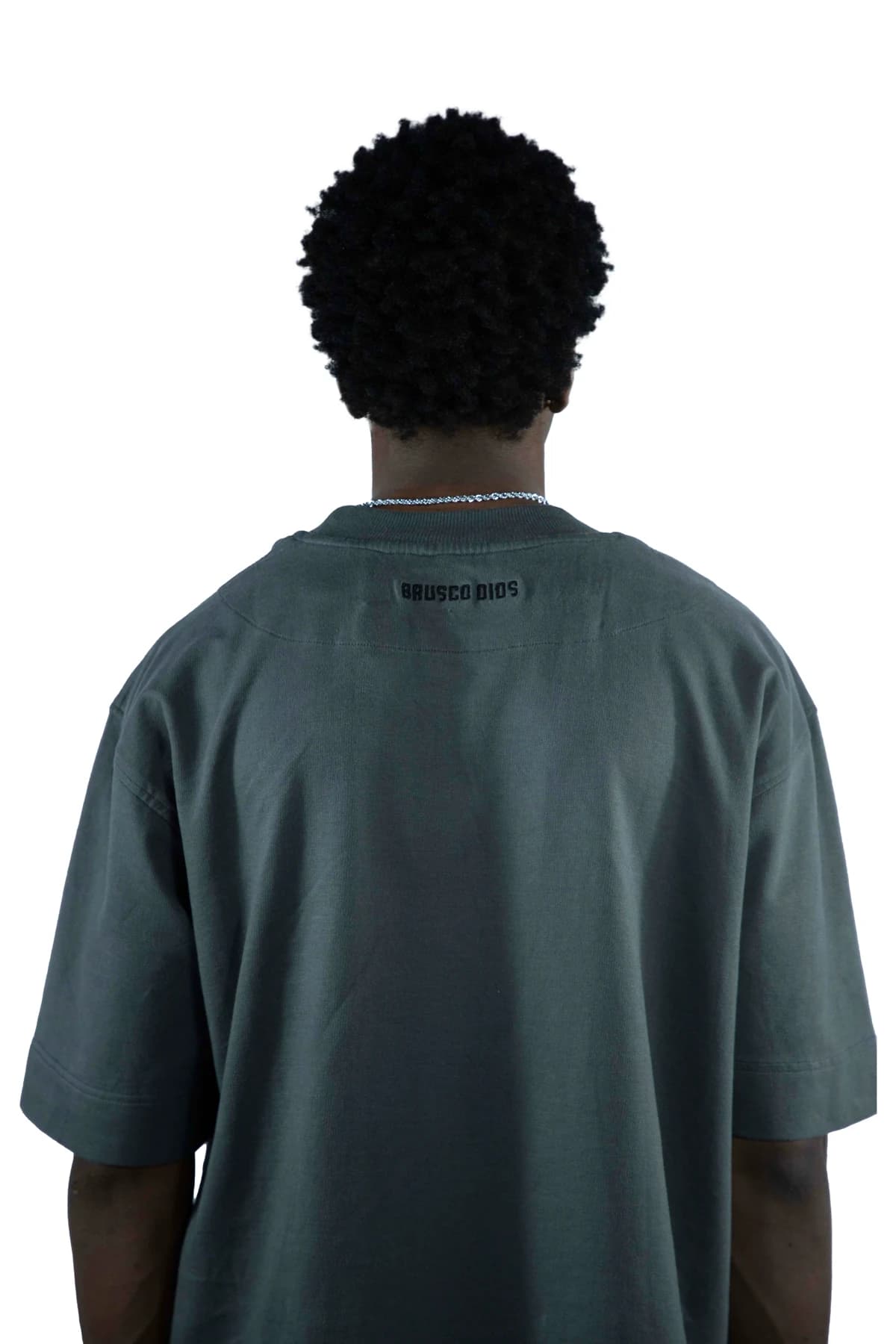 Back view of a model wearing an oversized dark T-shirt